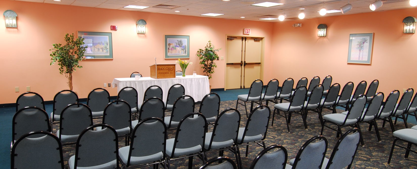 Meeting room with podium and chairs at Beach Colony Resort