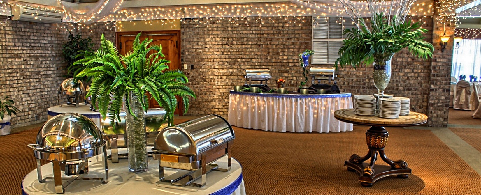 Banquet room at Caravelle Resort set up with plates and silver chafing dishes
