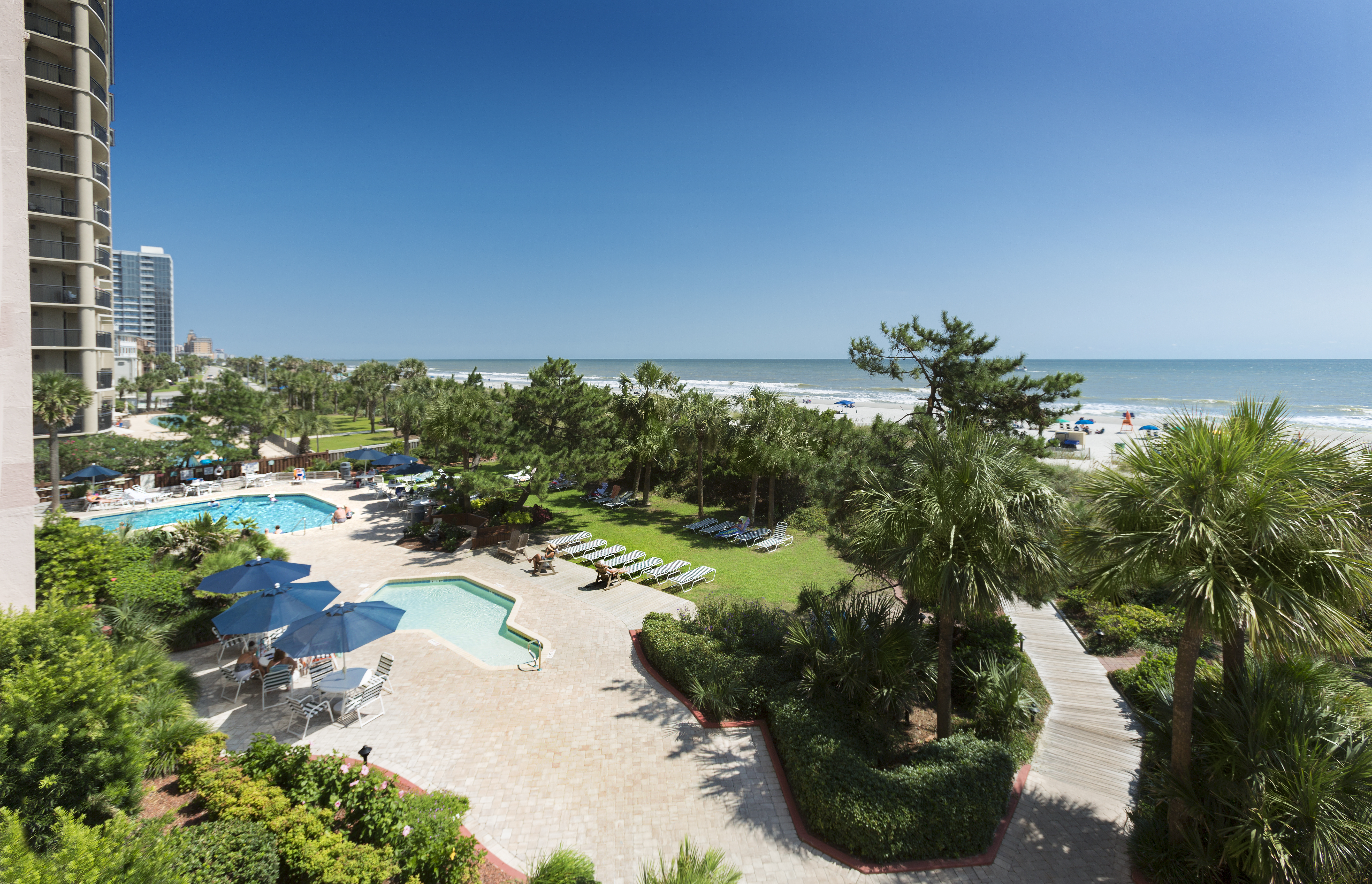 beach colony resort's oceanfront lawn and pool deck