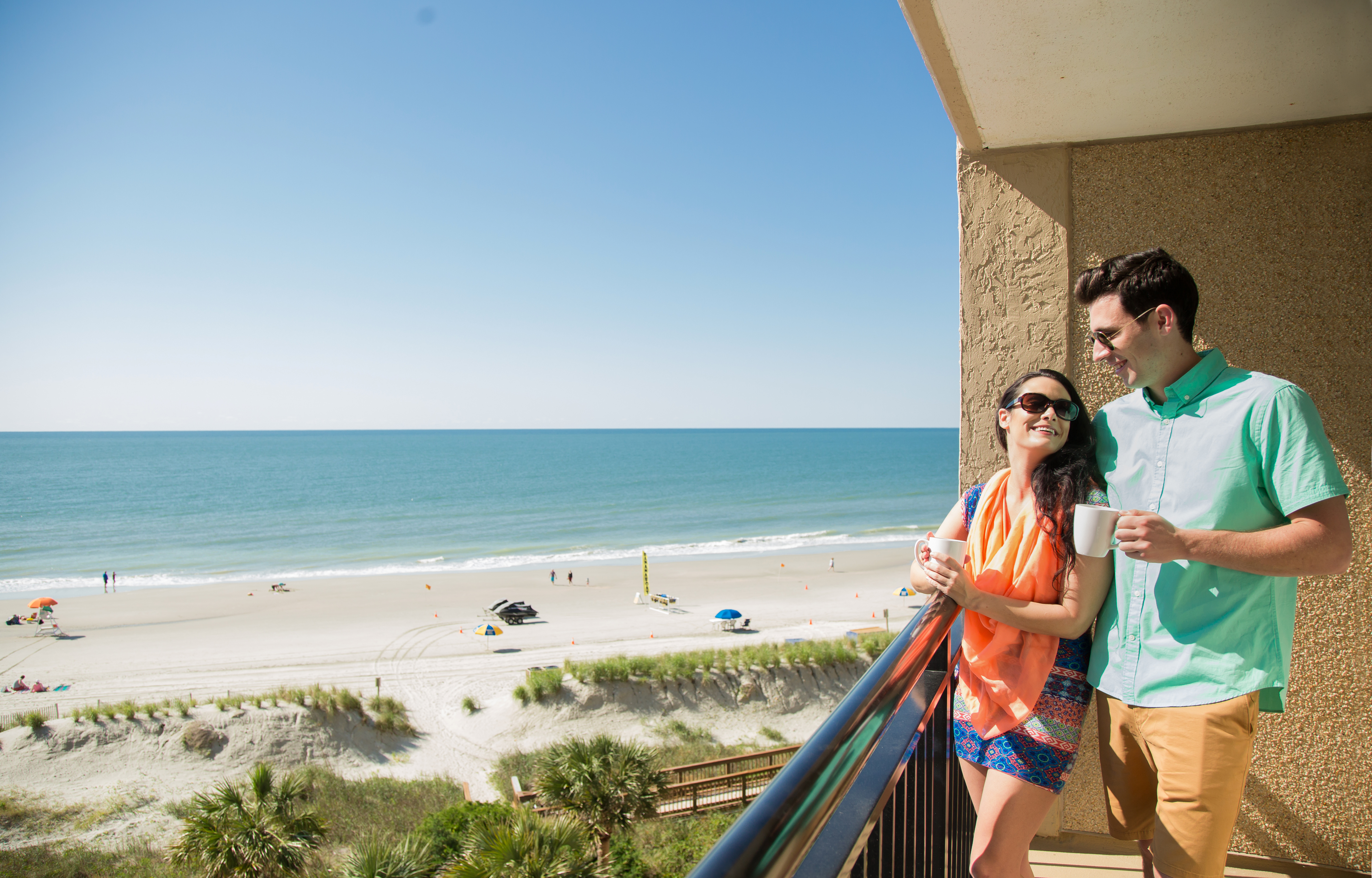 couple enjoying oceanfront view at beach cove resort