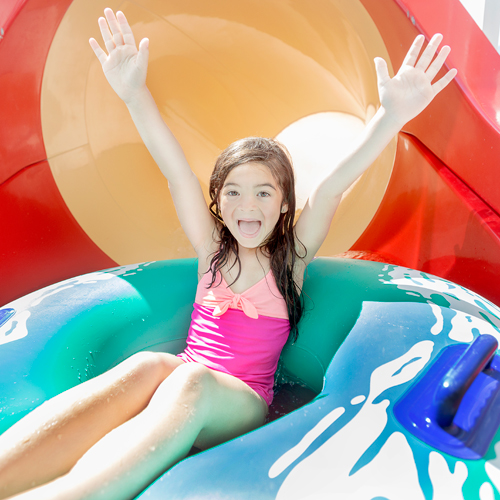 little girl on water slide at crown reef waterpark