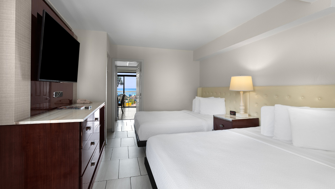 Bedroom with two beds and TV