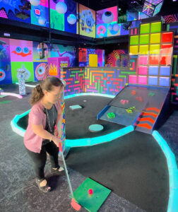 Person mini golfing